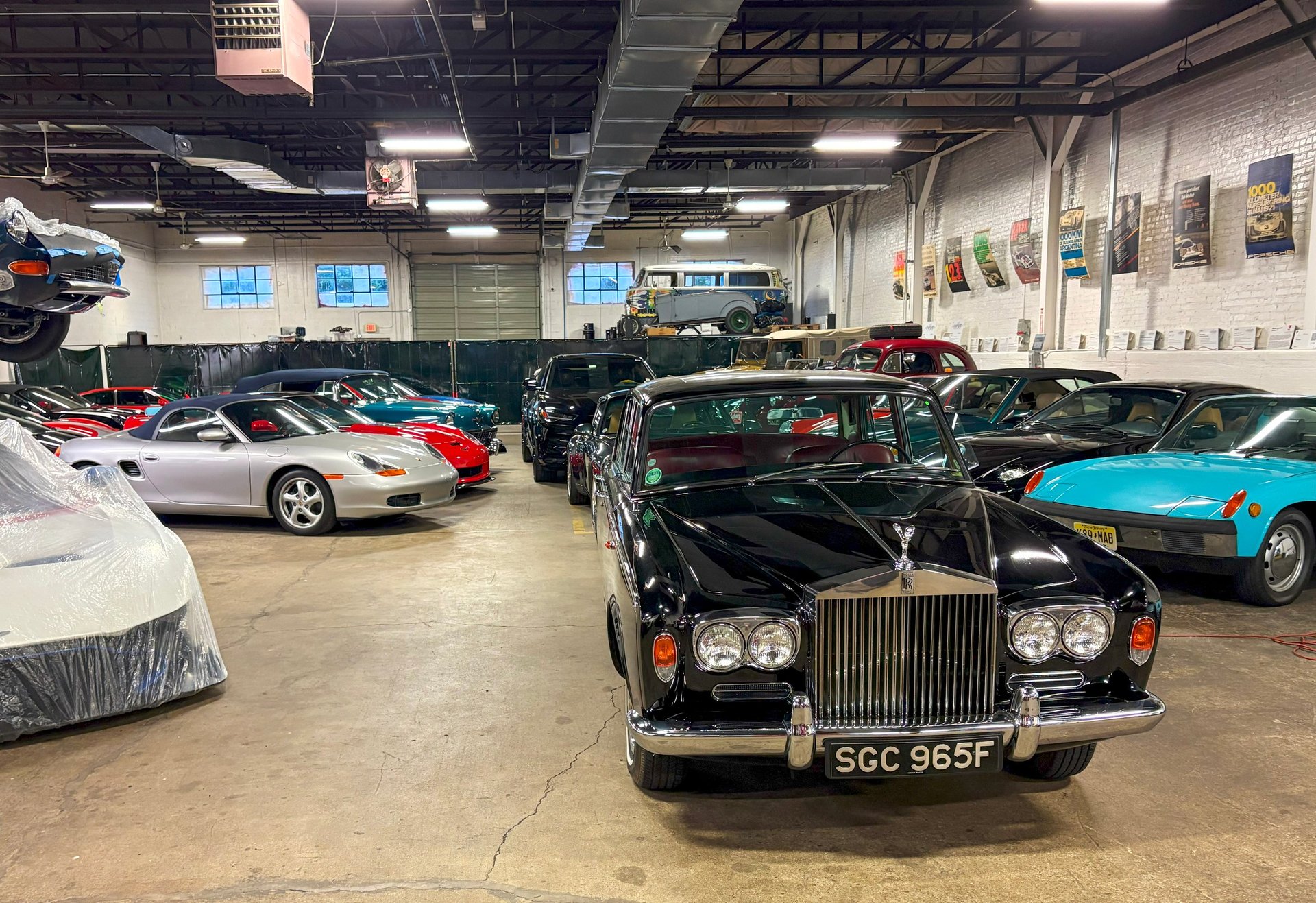 Numerous vintage and classic cars neatly arranged in an expansive garage space
