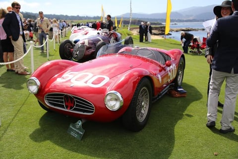 Red vintage racing car number 250 at outdoor event